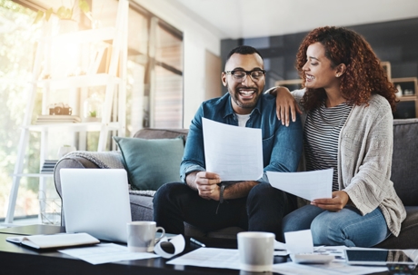happy couple discussing documents