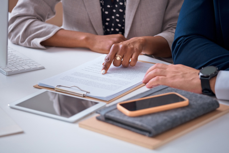 person reviewing paperwork with an attorney