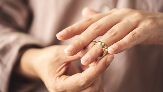 woman removing wedding ring